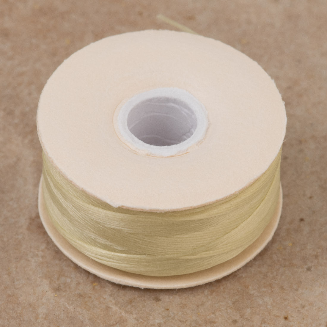 Size D Nymo Nylon Cream Thread bobbin