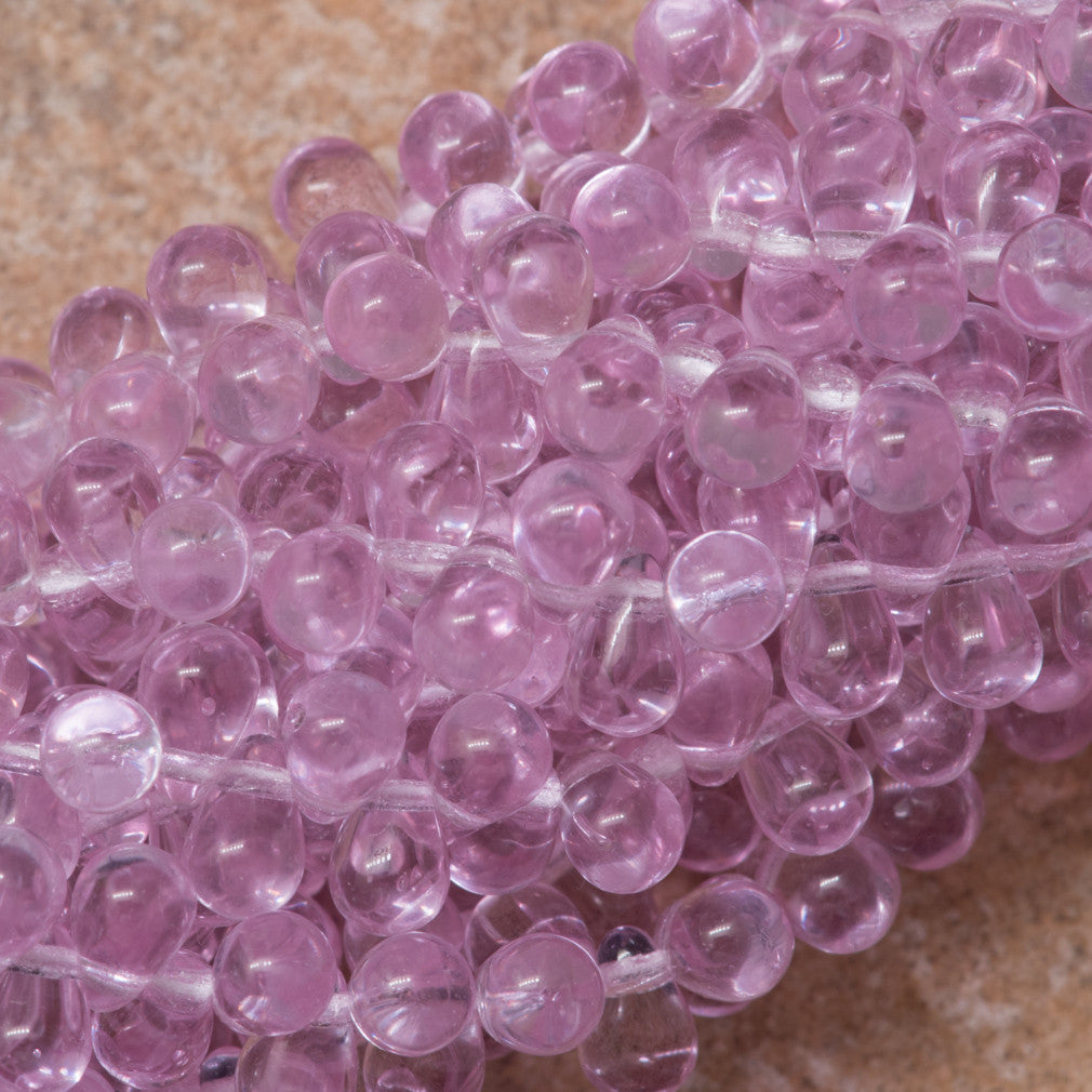 90 Czech 6x4mm Tear Drop Alexandrite Beads (20210) under warm lighting
