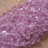 90 Czech 6x4mm Tear Drop Alexandrite Beads (20210) under warm lighting