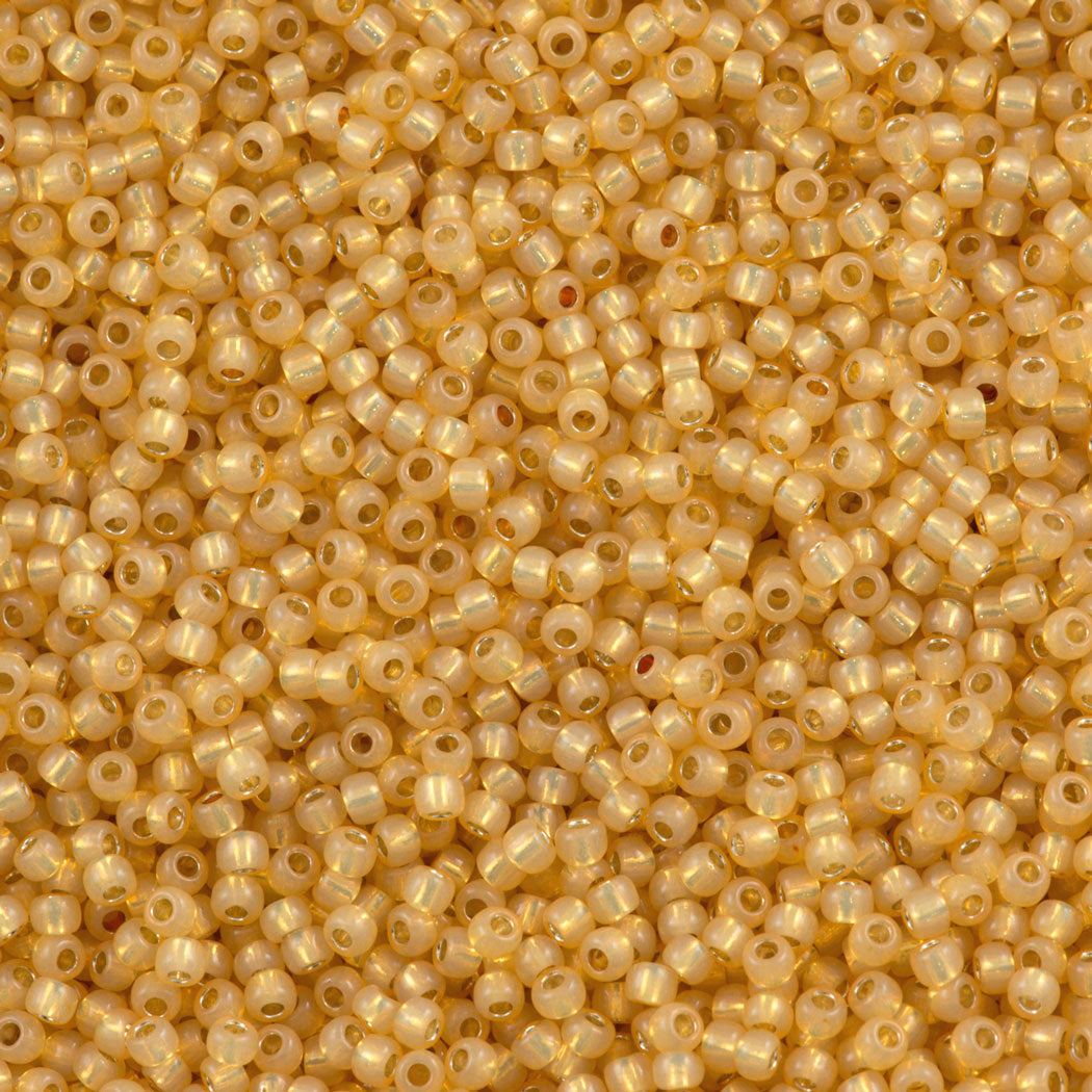 50g Toho Round Seed Bead 11/0 Silver Lined Milky Light Topaz (2110)